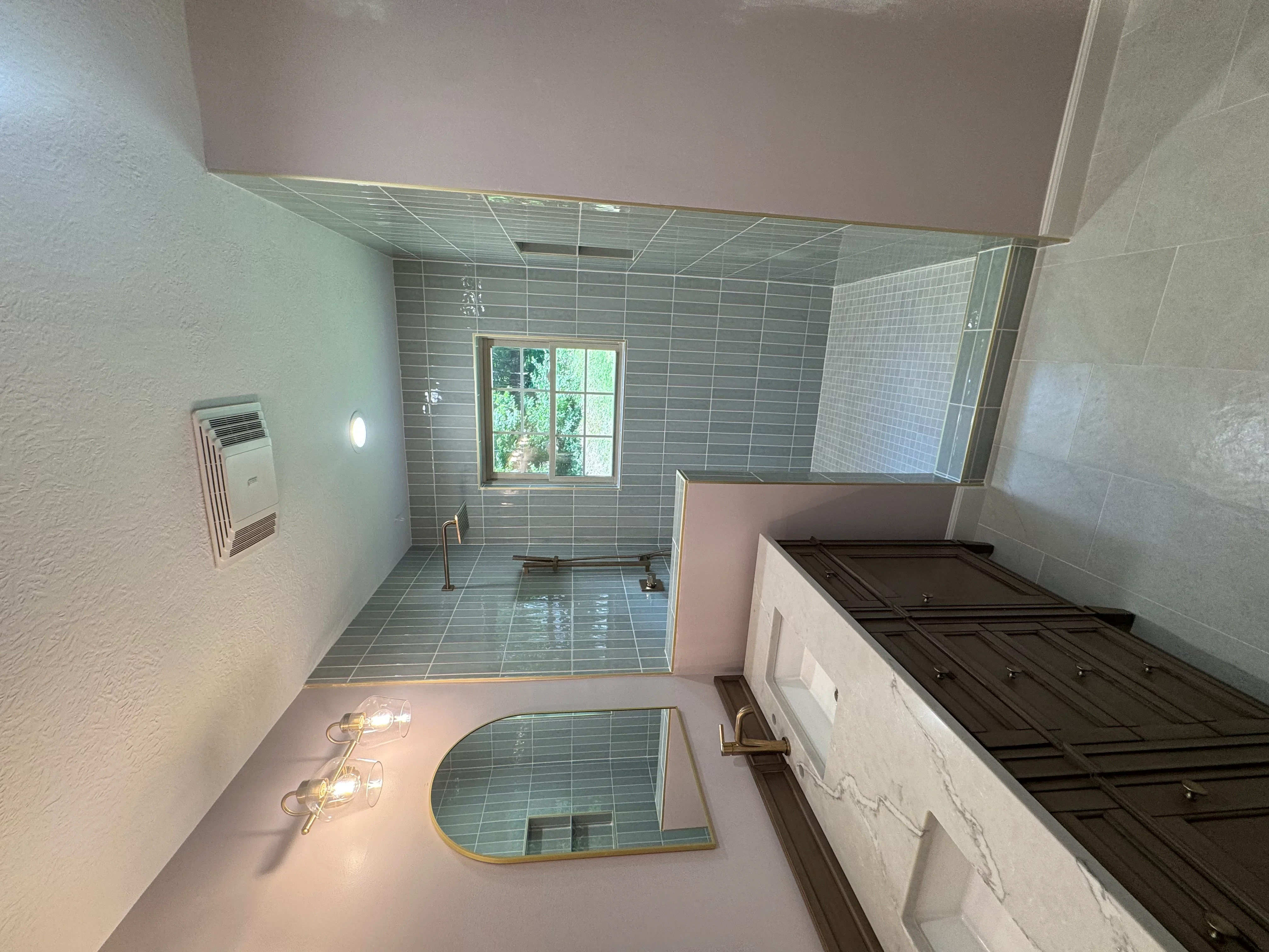 Bathroom with gray subway tile, glass shower enclosure, marble vanity, and recessed lighting