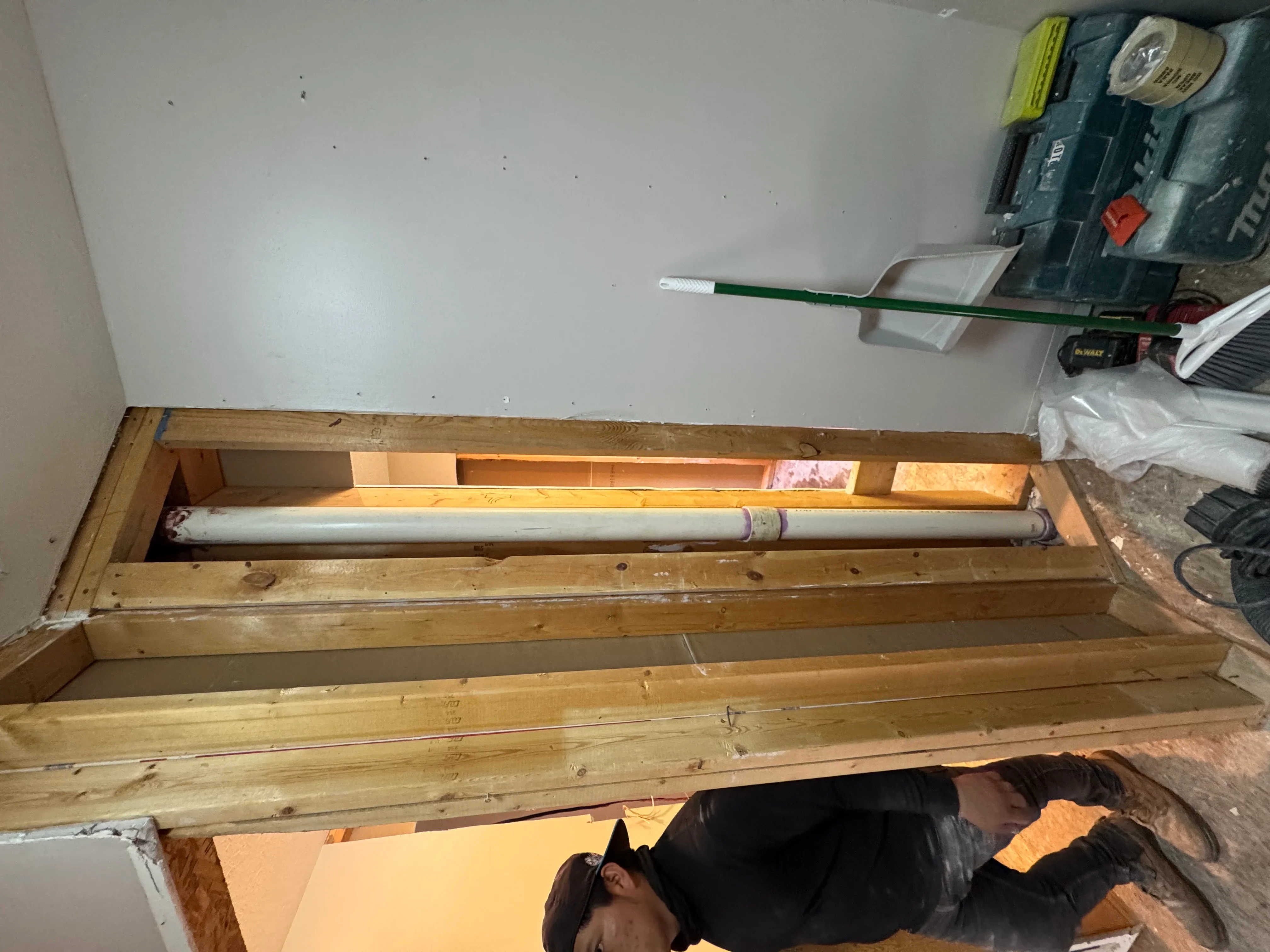 Wooden soffit frame with drywall backing and integrated lighting cavity during installation