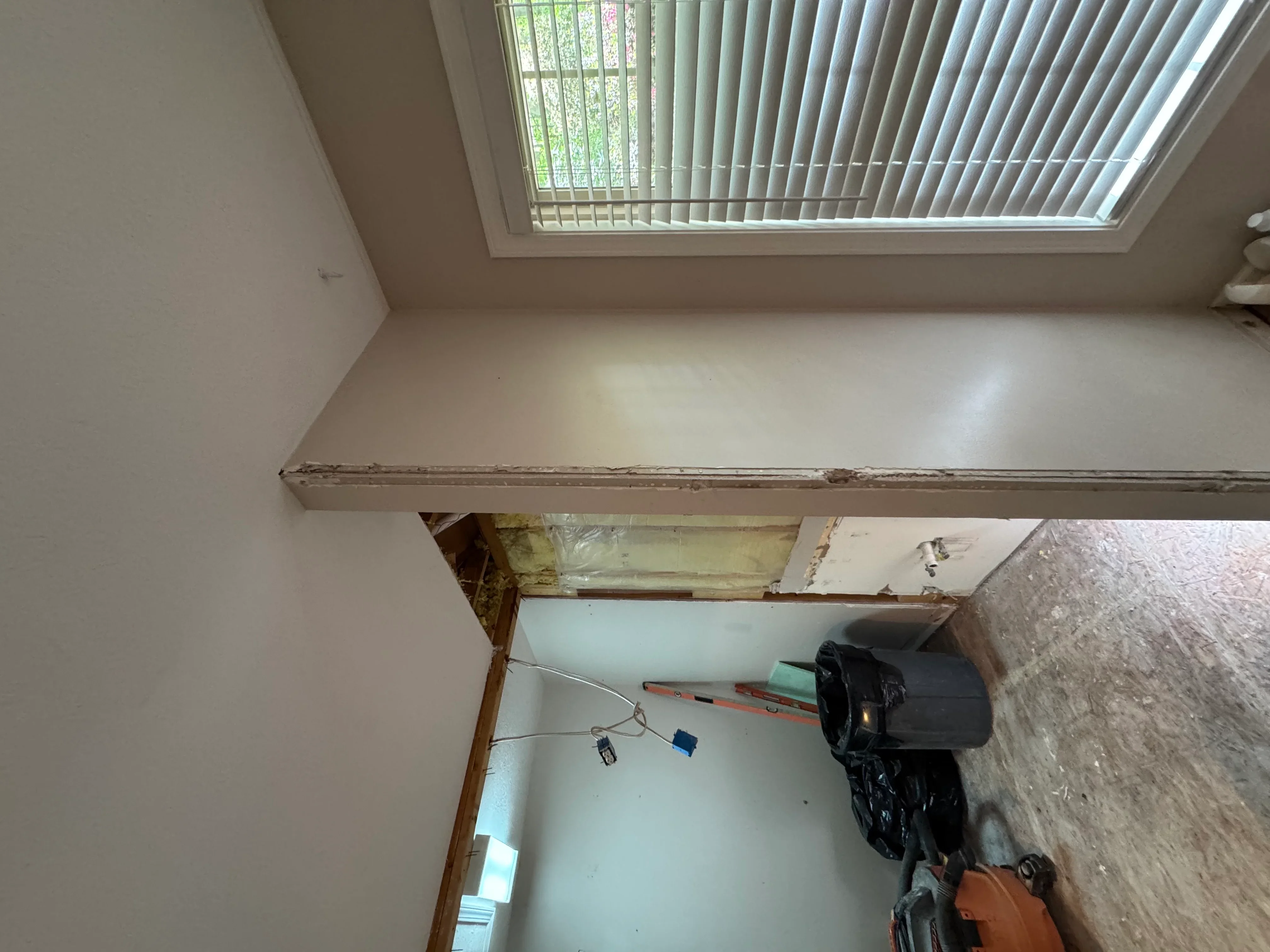 Finished drywall ceiling and walls with skylights, framing and installation in progress